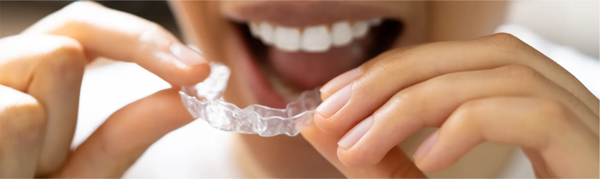 Image of person putting mourth guard on.