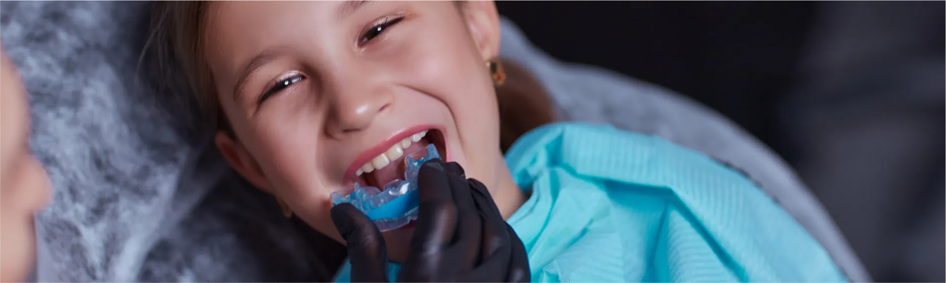 Kid getting sports mouth gaurd fitted.